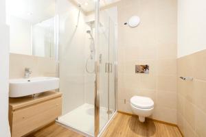 a bathroom with a shower and a toilet and a sink at JOIVY Superb Flats in the Heart of Edinburgh in Edinburgh +145 photos