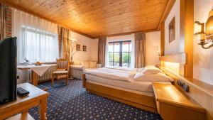 Postel nebo postele na pokoji v ubytování Hotel Alpina