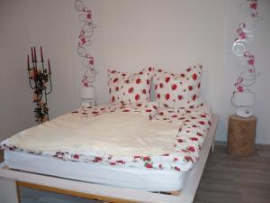 a bed with red hearts on it in a room at Ferienwohnung 500m zum See - a55874 in Vollrathsruhe