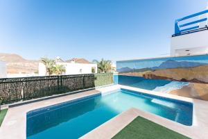 a swimming pool on the roof of a house at CT 297 AL - Faro's Villa Las Arenas - San José in Níjar