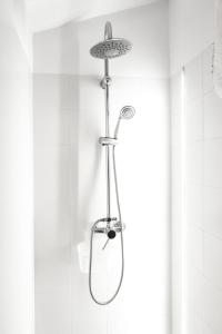 a shower with a shower head in a bathroom at Masia Villa Pilar Valderrobres in Valderrobres