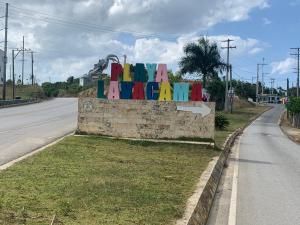 um sinal que diz happymite em uma parede ao lado de uma estrada em VILLA GRANDEZZA em Punta Cana