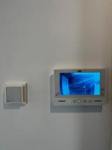 a television on a wall with a box on it at Apartment Island Krk Queen 1 in Krk