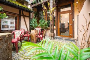 a group of chairs sitting outside of a restaurant at Hôtel Berceau Du Vigneron in Turckheim