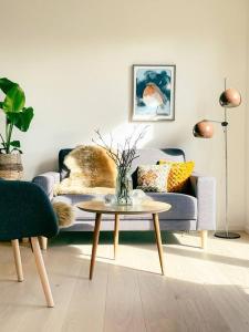 a living room with a couch and a table at 3 BR home for 9 guests in a quiet neighborhood in Tórshavn