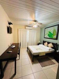 a room with a bed and a table and a dining room at Pousada Manga Rosa in Salvador
