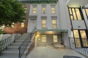 a large white building with stairs in front of it at 3 bedroom in Brooklyn