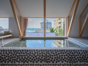 a swimming pool with a view of the ocean at Kameya Hotel in Tsuruoka