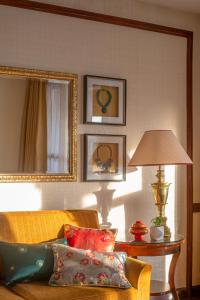 a living room with a couch and a table with a lamp at The Grand Dragon Ladakh in Leh