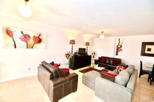 a living room with two couches and a tv at Palm Tree in São Martinho do Porto +39 photos