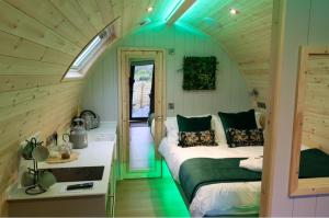a room with two beds in a small room at Primrose Glamping Pods in Ingleton 