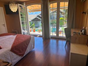 a bedroom with a bed and a sliding glass door at Hotel Boutique Cortijo Landete - SOLO ADULTOS in Granada +30 photos