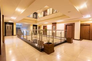 a lobby with a staircase in a building at Hotel Verandah in Itahari