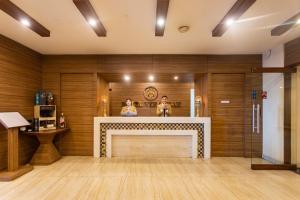 a fireplace in a room with wooden walls at Hotel Verandah in Itahari