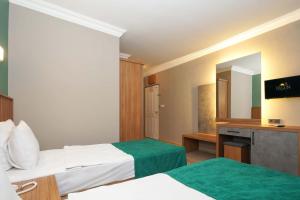 Postel nebo postele na pokoji v ubytování ERGÜN OTEL