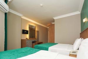 Postel nebo postele na pokoji v ubytování ERGÜN OTEL