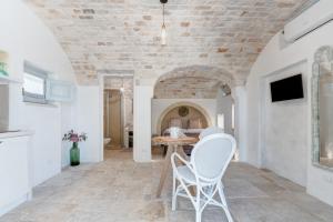 a living room with two chairs and a table at APOLLO House of Puglia in Monopoli
