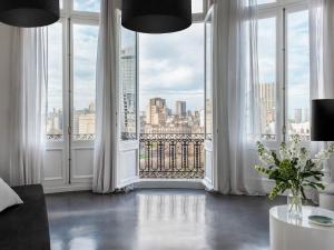 a room with large windows with a view of a city at HTL 9 de Julio BsAs in Buenos Aires