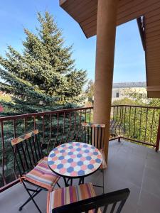 a patio with a table and chairs on a balcony at Svečių namai Vilma in Šventoji +19 photos