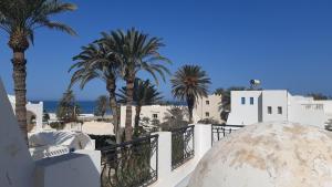a view from the balcony of a house with palm trees at Maison de sirène in Zarzis