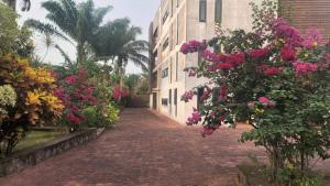 an empty street with flowers and a building at BEACHFRONT APPARTMENT in Kribi