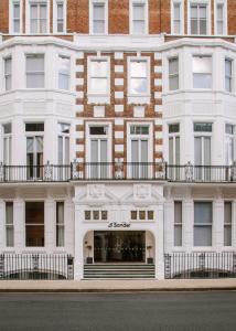 a white building with a balcony on a street at Sonder The Gilbert in London