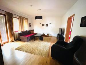 a living room with a couch and a table at Nera-etwa Konjic 1 apartment in Konjic