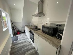 a kitchen with a counter top and a microwave at Coastal Tyneside Flat in Westoe