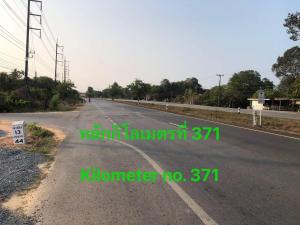 an empty road with green graffiti on the side of the road at Garden Home, Chanthaburi in Ban Bo