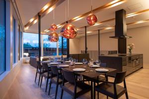 a dining room with a long table and chairs at Yuki Sugi at Intuition in Kutchan