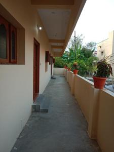 an empty hallway of a building with potted plants at SriArunachala Shiva home stay in Tiruvannāmalai