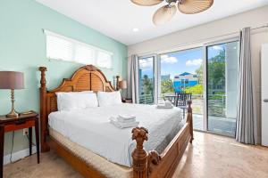 a bedroom with a bed and a large window at A Somewhere is Here by Beachside Management in Siesta Key +77 photos