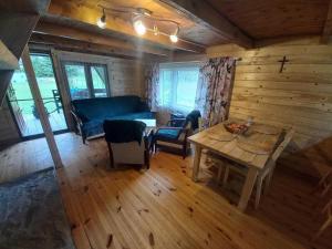 a living room with a blue couch and a table at U Dziadka 