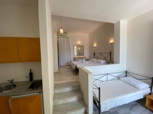 a small room with two beds and a kitchen at Hotel Plakures in Falasarna