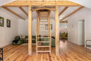 a loft bed in a room with a ladder at Suite mit Dachterrasse in Dedelstorf