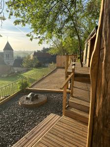 a wooden stairway with a dog laying on the ground at Coeur de Lodge spa privatif in Cramoisy