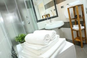 a bathroom with a shower and a pile of towels at Apartments Old Town in Trogir