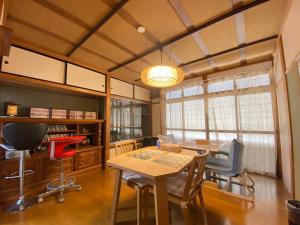 a dining room with a table and chairs at Guesthouse Takayama Hanzansha in Takayama
