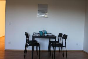 a black table with four chairs in a room at Zweites Zuhause in Recklinghausen +3 photos
