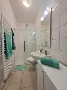 a bathroom with a sink and a toilet and a shower at Apartment Sandy in Hvar