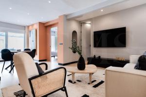 een woonkamer met meubilair en een flatscreen-tv bij Apartment with terrace steps from beach REMS in Fuengirola