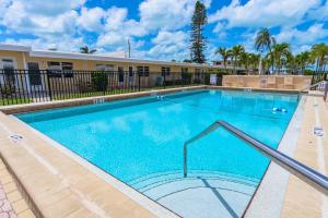 a large swimming pool in front of a building at Casa Mar By Beachside Management in Sarasota