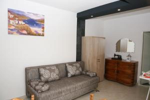 a living room with a couch and a mirror at Apartments Old Town in Trogir