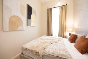 a bedroom with a bed and a window at Cozy Boulevard Apartment in the Heart of Budapest in Budapest +18 photos
