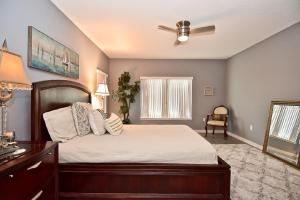 a bedroom with a bed and a ceiling fan at Family Tides in Siesta Key