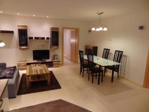 a living room and dining room with a table and chairs at WM-Appartements in Haus im Ennstal