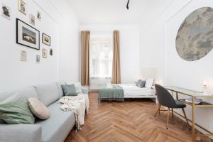 a living room with a couch and a bed at Krupnicza Modern Old Town Apartments - by Upstairs in Kraków