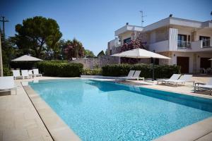 a swimming pool in front of a house at Villa D'Aprile Exclusive Luxury Villa with pool, Jacuzzi, SPA in Castellana Grotte