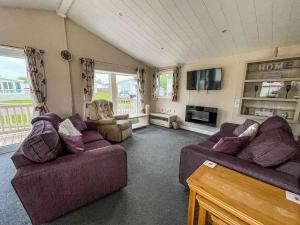 a living room with two couches and a tv at Beautiful 6 Berth Lodge With Disabled Access At Cherry Tree Ref 70829c in Great Yarmouth