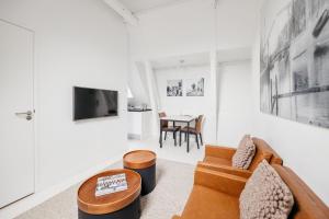 a living room with a couch and a table at YAYS Amsterdam Salthouse Canal by Numa in Amsterdam